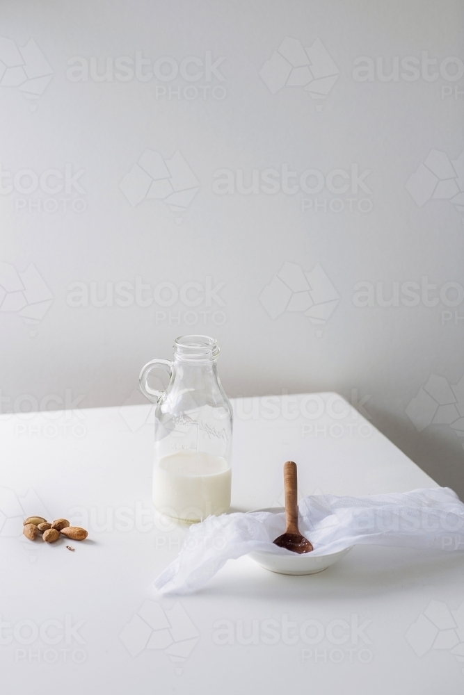 Glass bottle filled with nut milk - Australian Stock Image