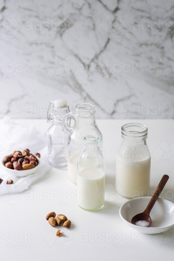 Glass bottles filled with nut milk - Australian Stock Image