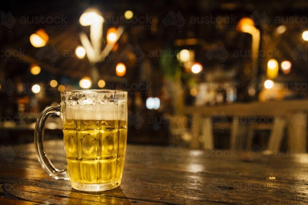 Glass of cold beer sitting on a table - Australian Stock Image