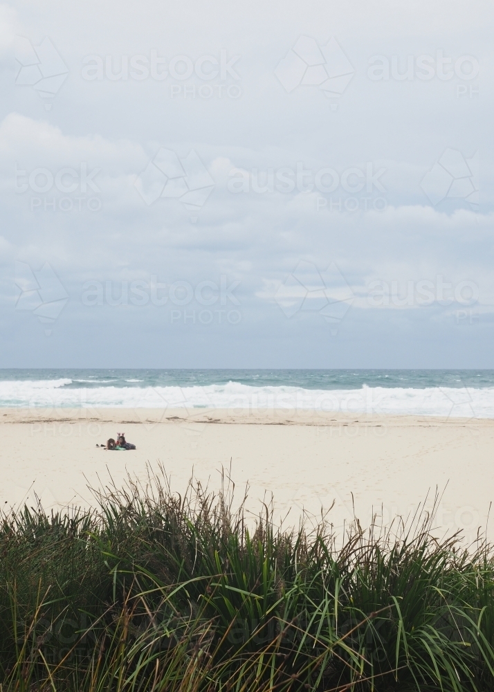 Gloomy day at the beach with just two people - Australian Stock Image