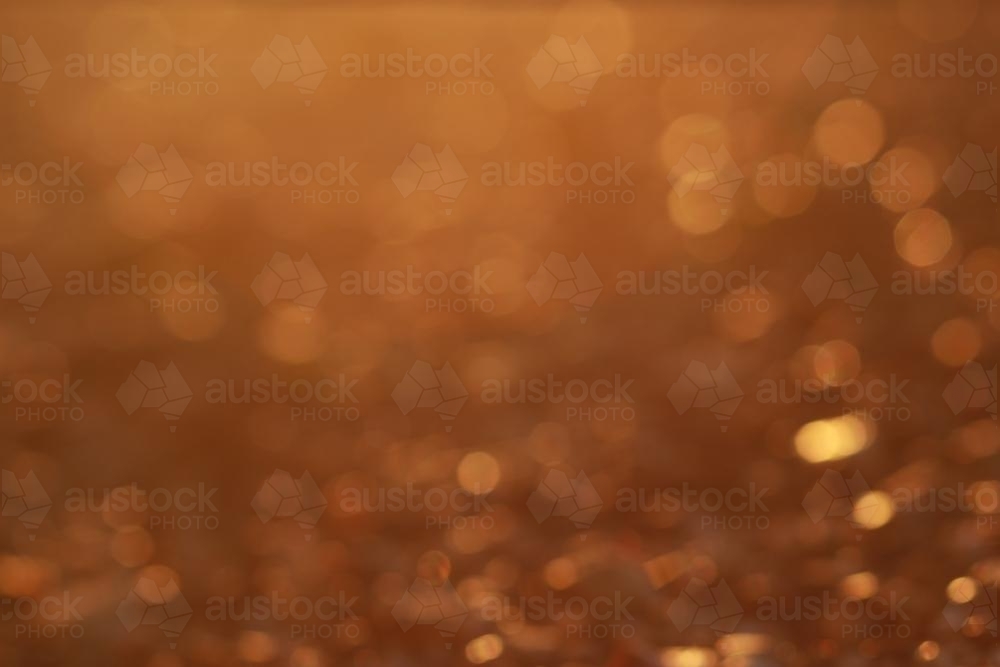 Golden bokeh of rocks in the afternoon sunlight - Australian Stock Image