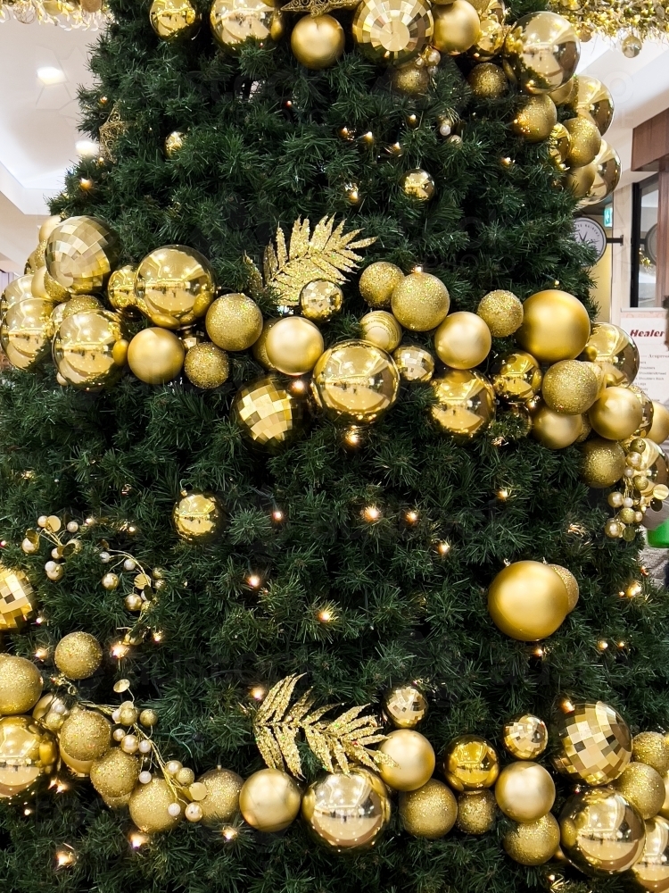 Golden decorations on a christmas tree - Australian Stock Image