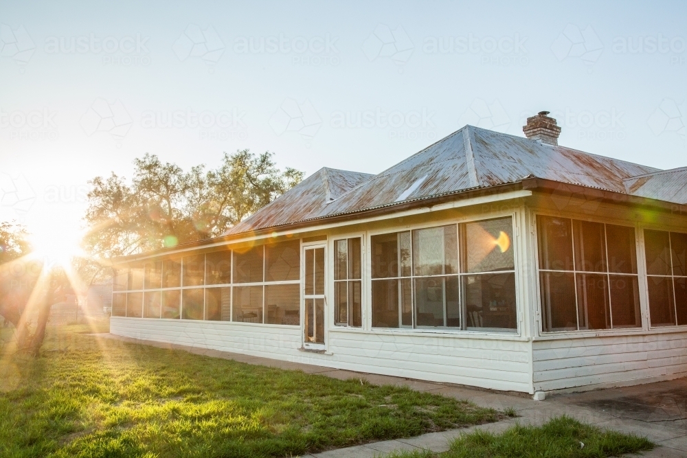 Golden light shining over rural homestead in summer - Australian Stock Image