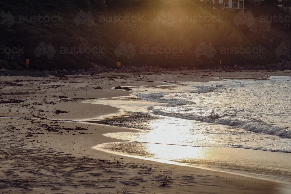 Golden sunlight on the beach in late afternoon - Australian Stock Image