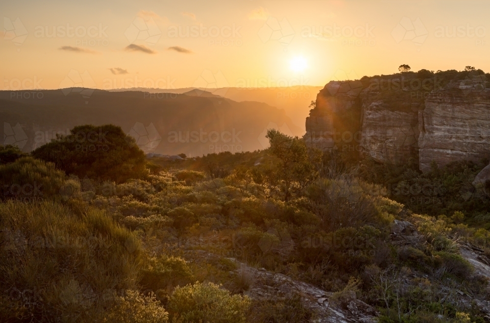 Golden sunset across the rugged escarpment cliffs - Australian Stock Image
