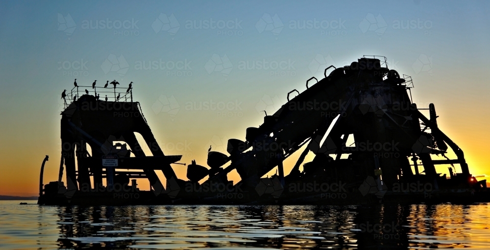 Golden sunset over sunken shipwrecks - Australian Stock Image