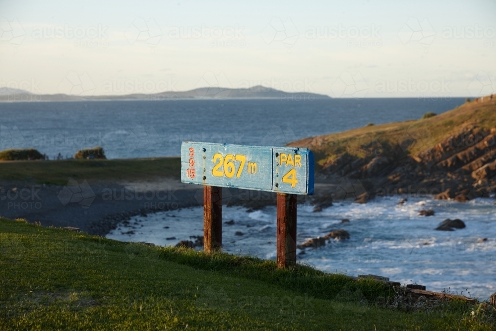 Golf course sign at coastal landscape on sunrise - Australian Stock Image