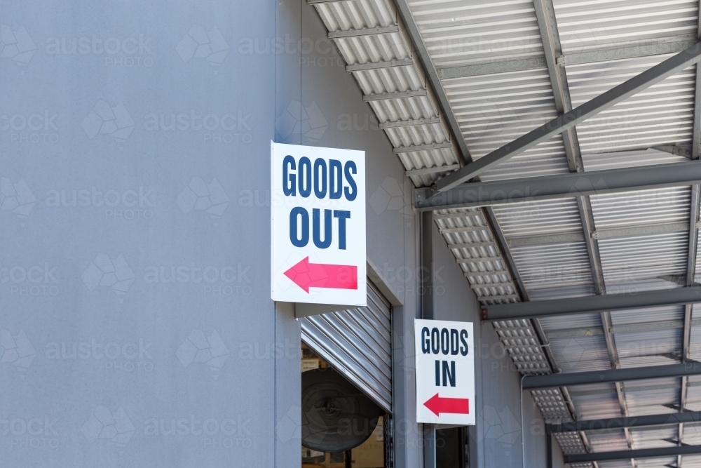 Goods shed with signs for deliveries in and out - Australian Stock Image
