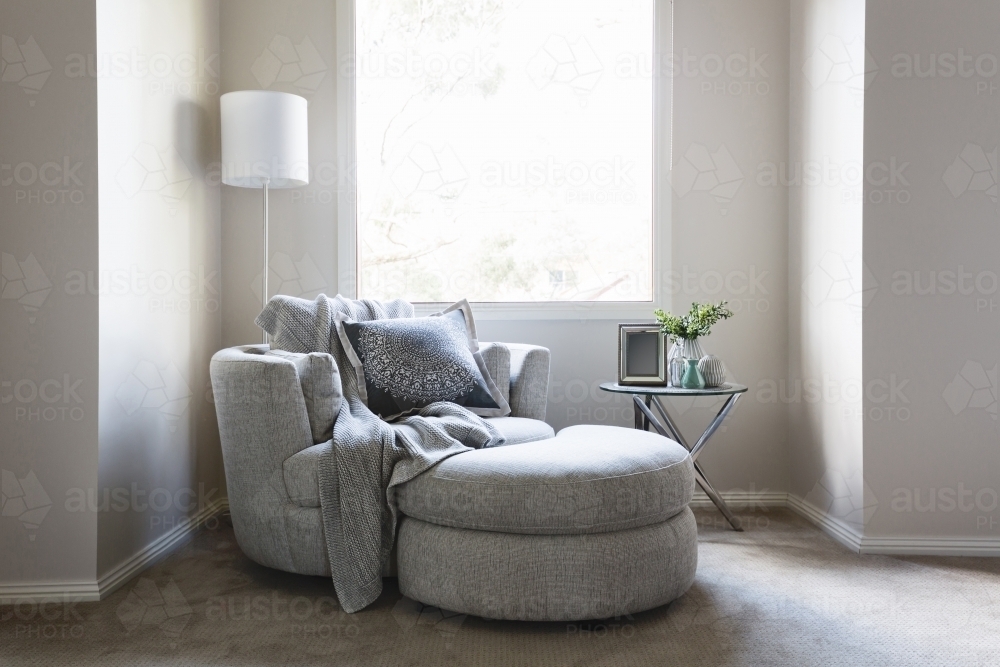 Gorgeous bedroom sofa chair with throw rug and cushion - Australian Stock Image