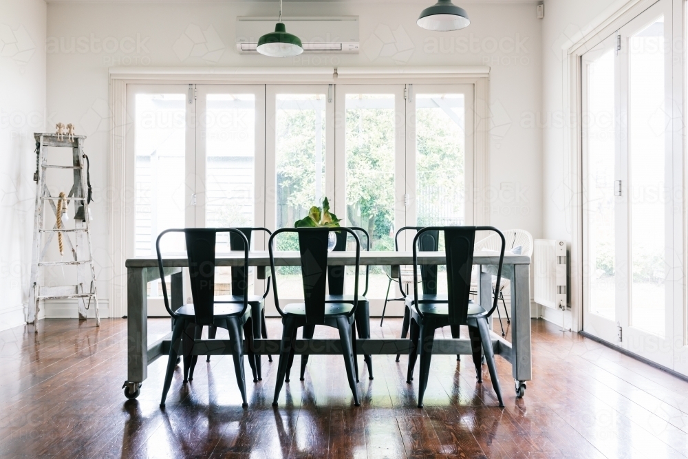 Gorgeous vintage styled dining room with bifold doors - Australian Stock Image