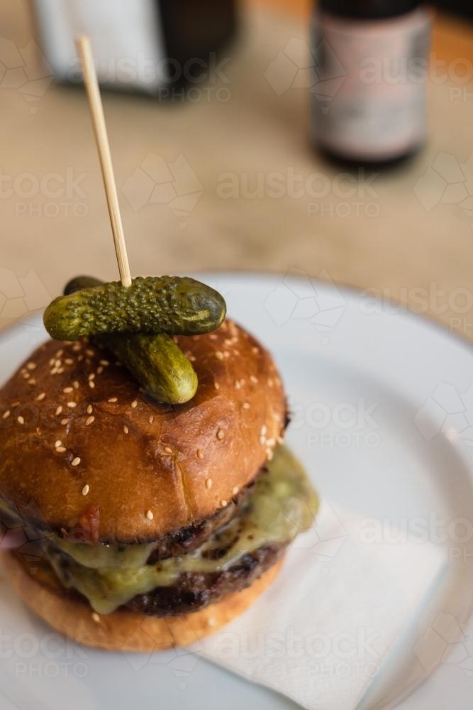 gourmet hamburger with pickles on top - Australian Stock Image