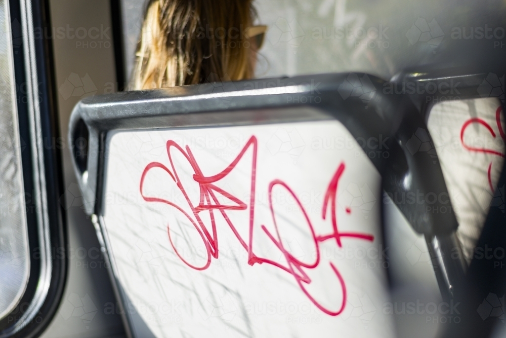 Graffiti on back of bus seat - Australian Stock Image