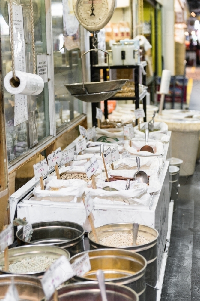 Grain and beans with old fashioned scales at a food market - Australian Stock Image