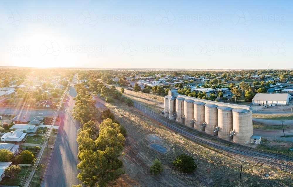 Grain silos beside a railway track and road in a country town - Australian Stock Image