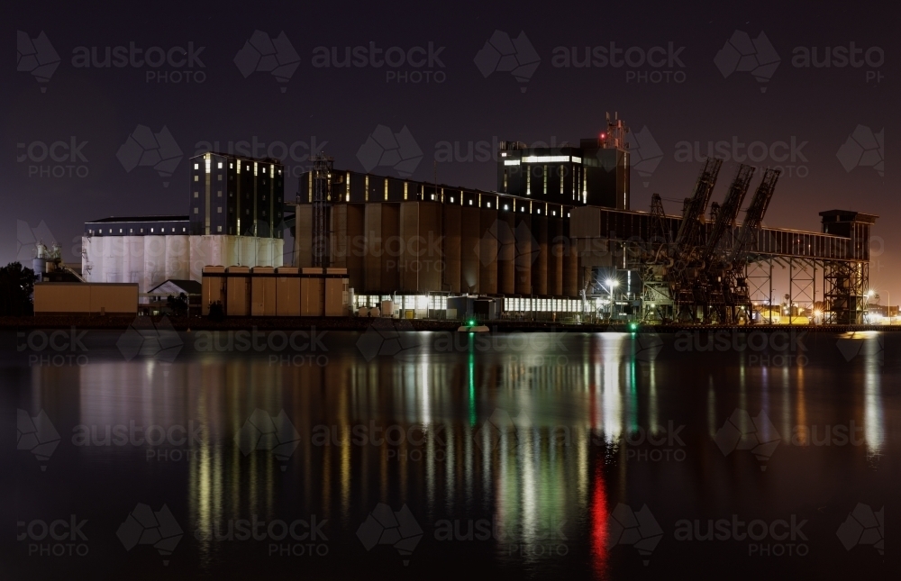 Carrington silos at night with lights reflected in water - Australian Stock Image