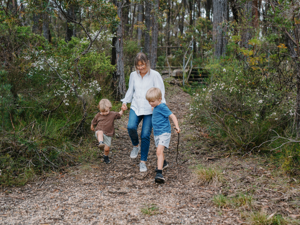 Grandmother enjoying Australian Bushland with her Grandchildren - Australian Stock Image