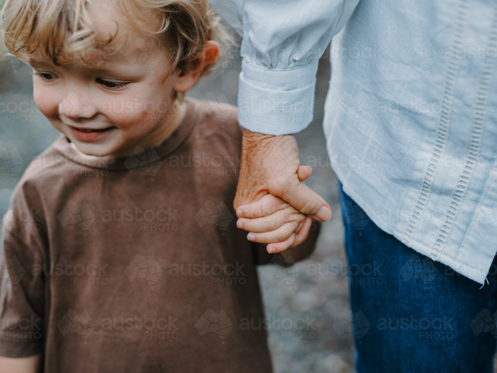 Grandmother holding grandsons hand - Australian Stock Image