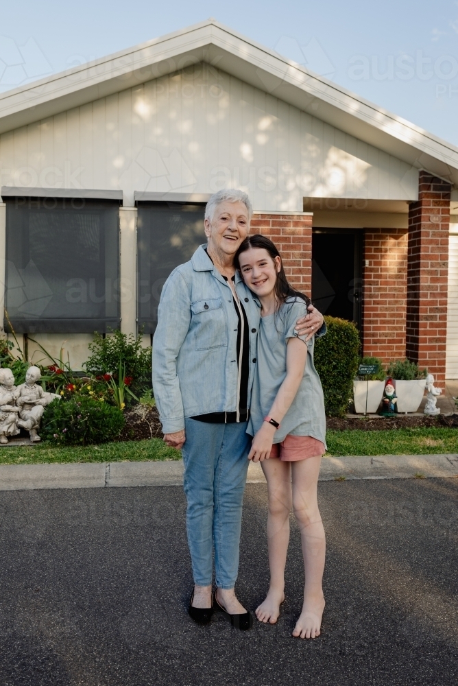 Grandmother "Ma" hugging her granddaughter in front of her retirement home - Australian Stock Image