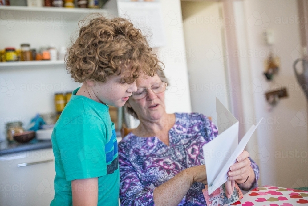 Grandmother reading card to grandson - Australian Stock Image