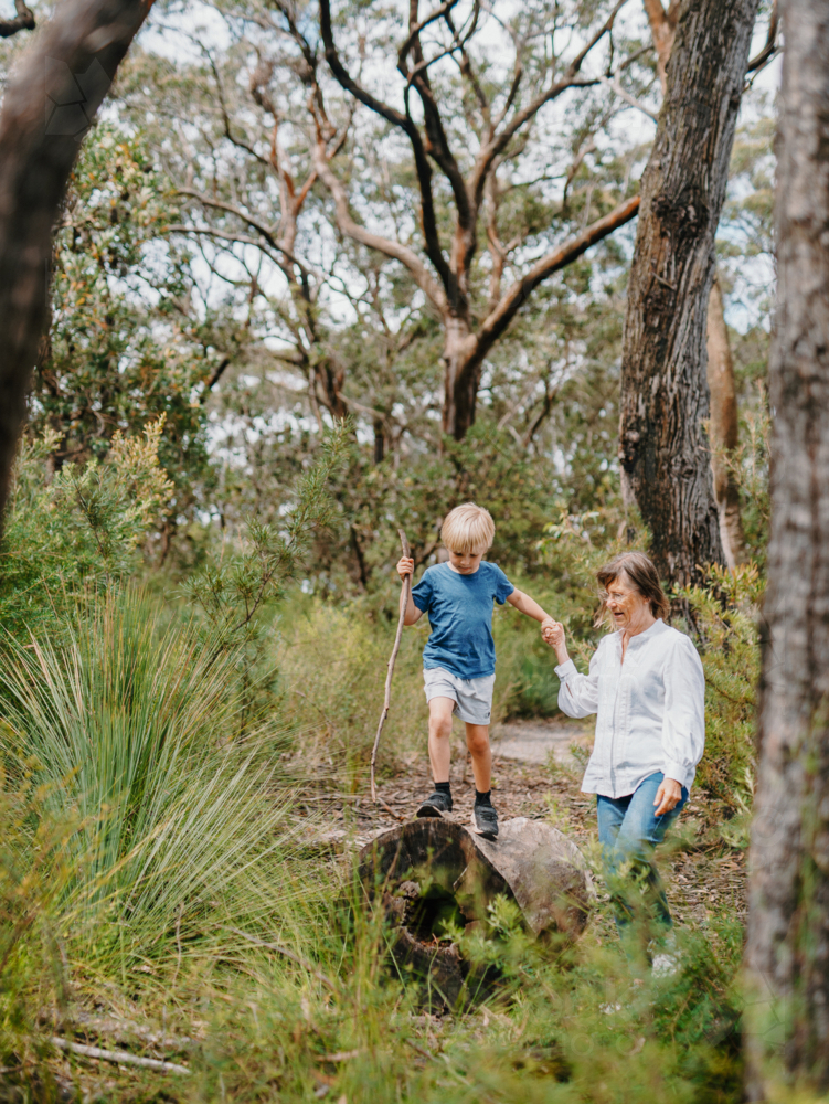 Grandmother spending time with grandson in nature exploring the bush - Australian Stock Image