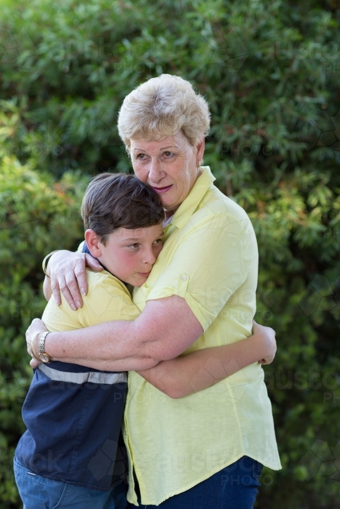 Grandson hugging his grandmother - Australian Stock Image