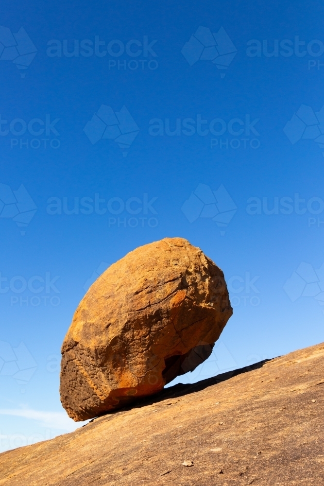 granite boulder balancing on rock at Berringbooding - Australian Stock Image