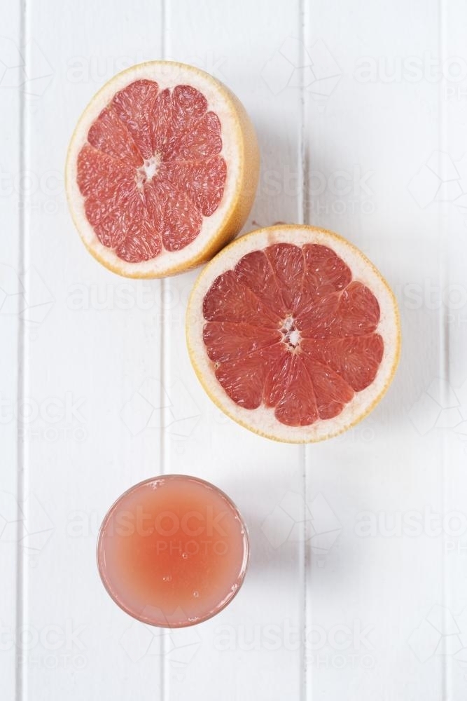grapefruit juice on white background - Australian Stock Image