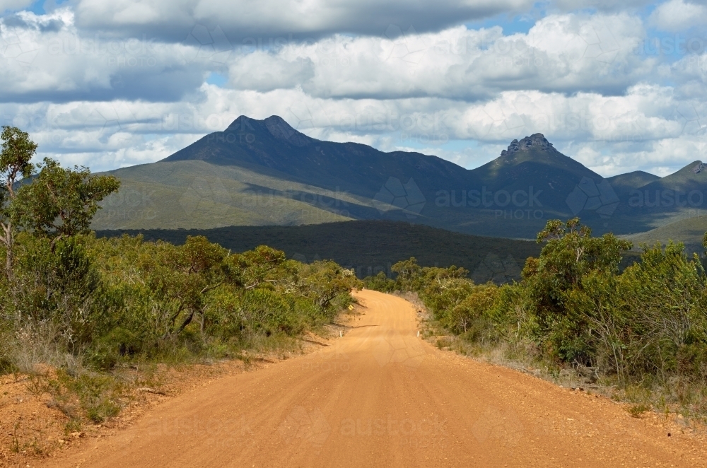 Gravel Road Heading Towards Mountains - Australian Stock Image