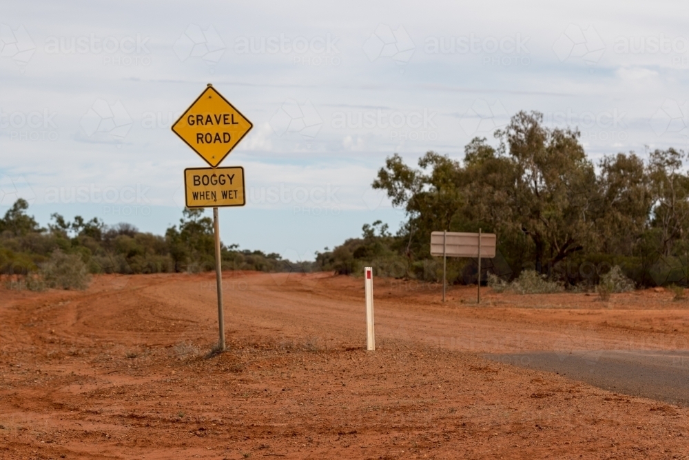 Gravel Road sign on red dirt road - Australian Stock Image