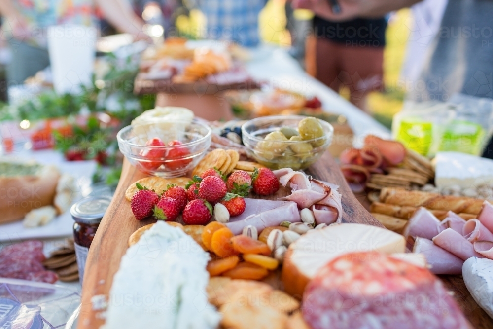 Grazing table antipasto food of cheese meats and berries - Australian Stock Image