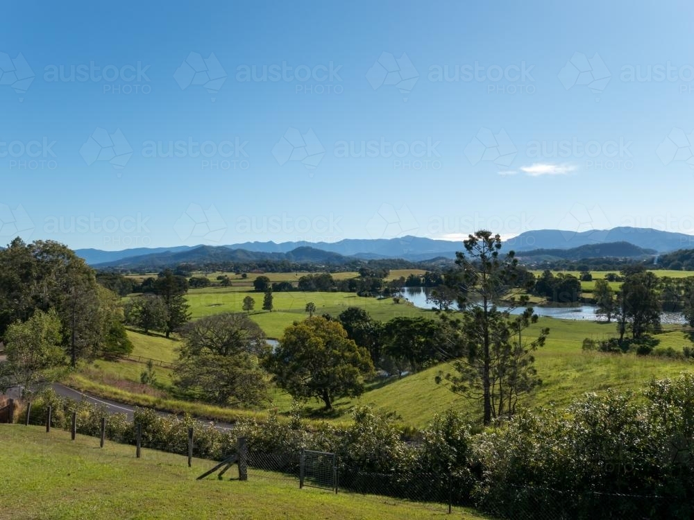 Green and lush Tweed Valley landscape under blue sky - Australian Stock Image