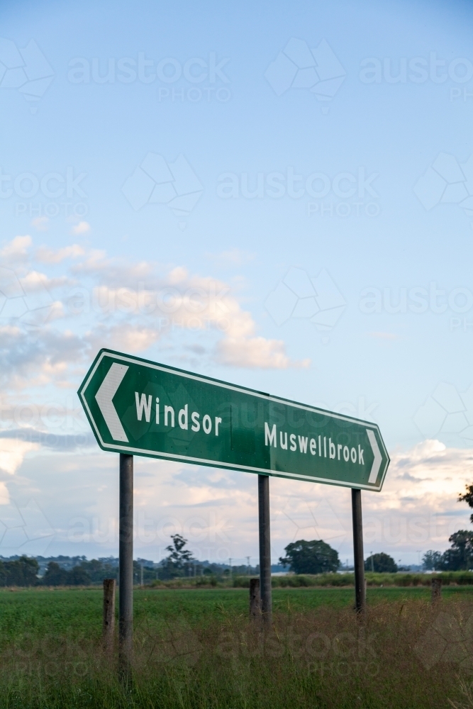 Green Aussie road sign pointing to Windsor and Muswellbrook - Australian Stock Image