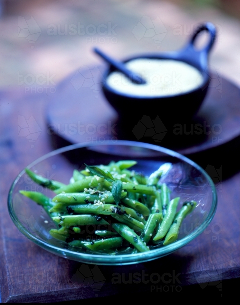 Green beans served in a small glass dish in a Japanese restaurant - Australian Stock Image