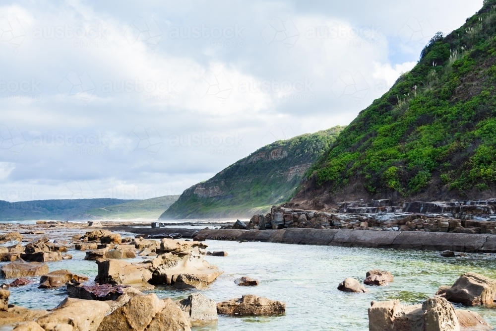 green coastal cliffs and sea spray landscape - Australian Stock Image