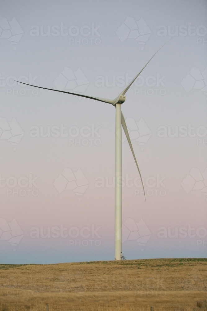 Green energy wind turbine in the countryside at dusk - Australian Stock Image