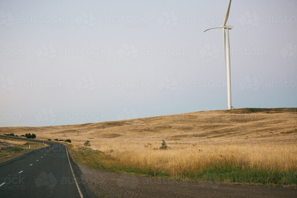 Green energy wind turbine in the countryside at dusk - Australian Stock Image