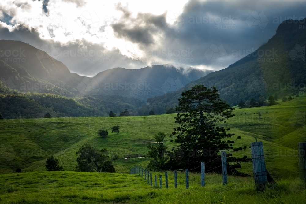 Green farming valley surrounded by Mountains - Australian Stock Image