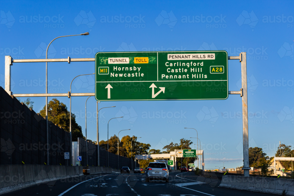 Green overhead road signage before NorthConnex tunnel with directions to Hornsby and Pennant Hills - Australian Stock Image