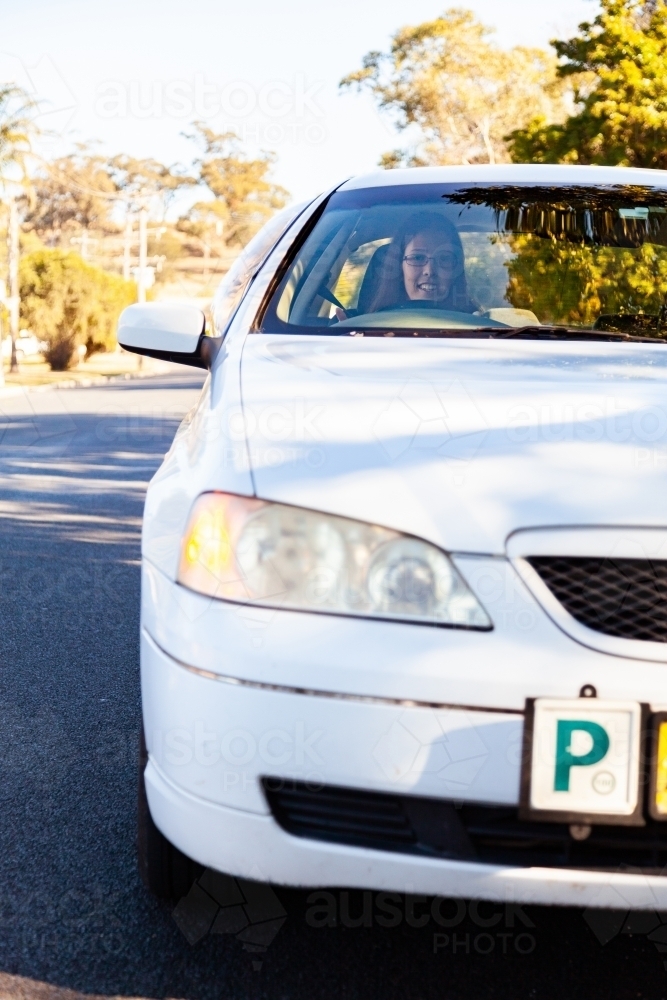 Green p plate driver car indicating before pulling out from curb - Australian Stock Image