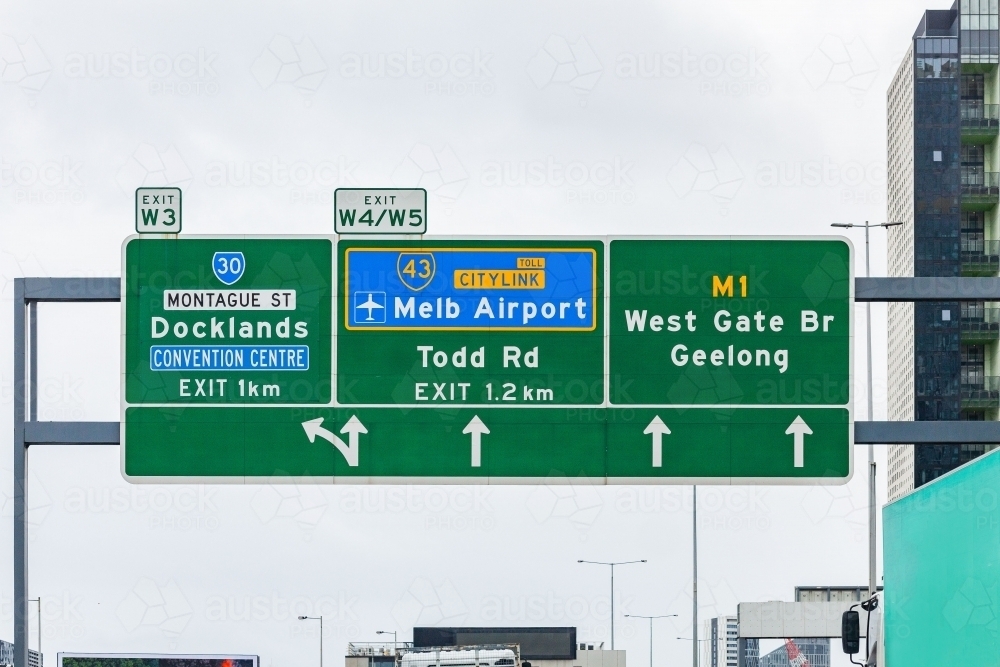 green road sign with directions to exits and citylink to Melbourne airport - Australian Stock Image