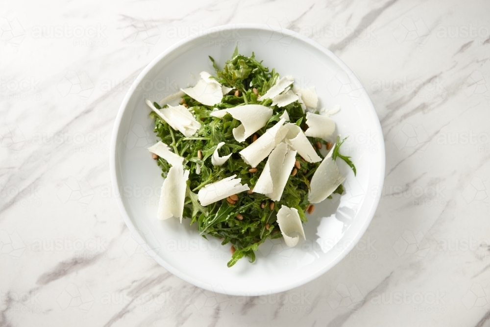 green salad mixed with nuts and largely grated cheese - Australian Stock Image