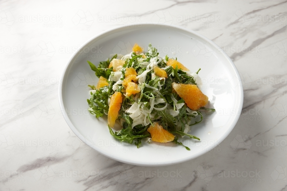 green salad with orange slices and grated cheese - Australian Stock Image