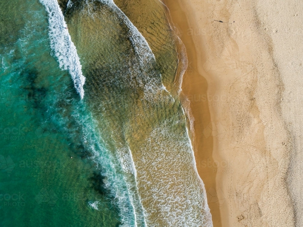 Green sea water with golden beach sand from overhead aerial perspective  - Australian Stock Image