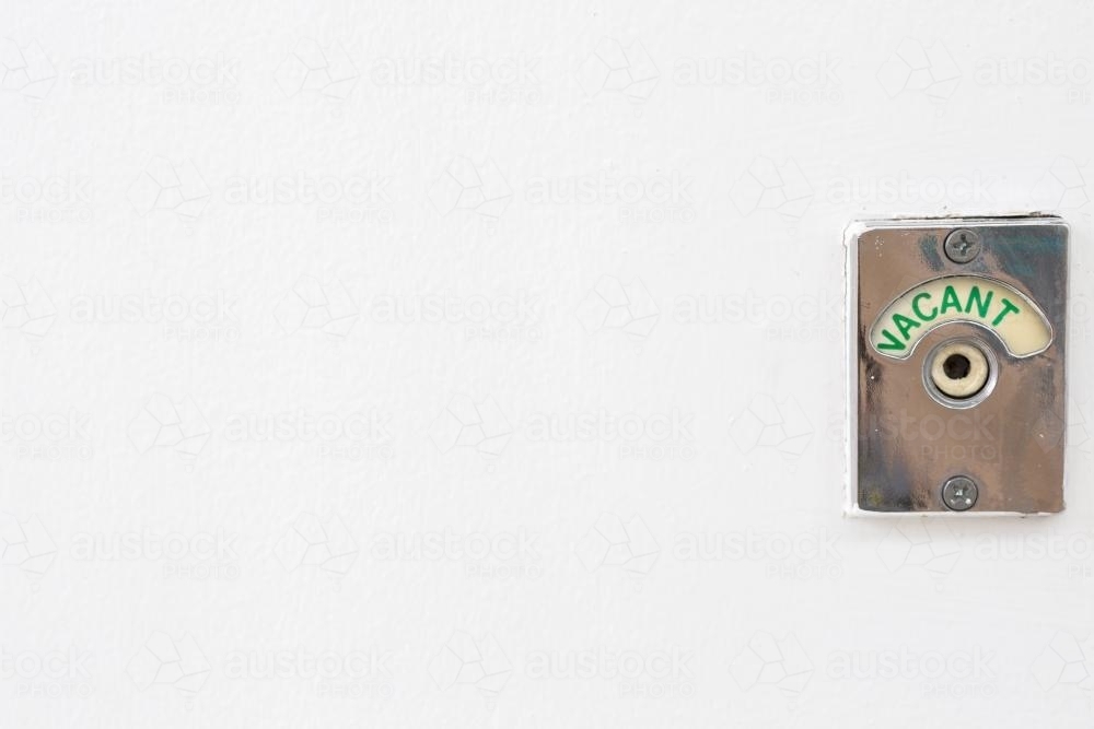 Green vacant sign turned on in public toilet. - Australian Stock Image