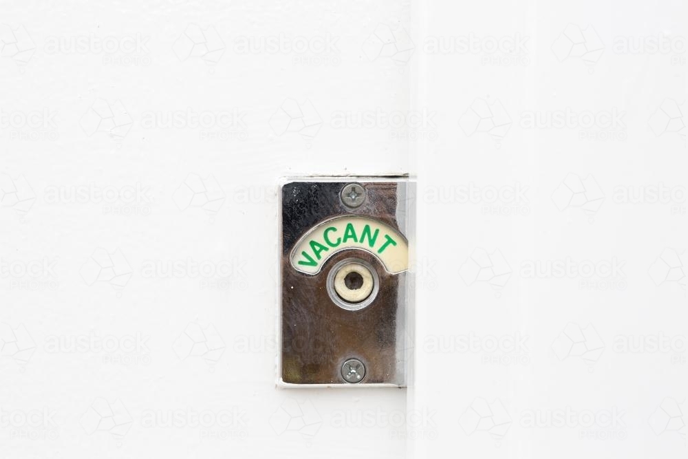 Green vacant sign turned on in public toilet - Australian Stock Image