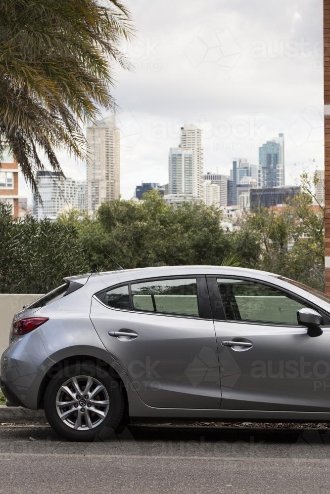 Grey car parked in Sydney with the cbd skyline - Australian Stock Image