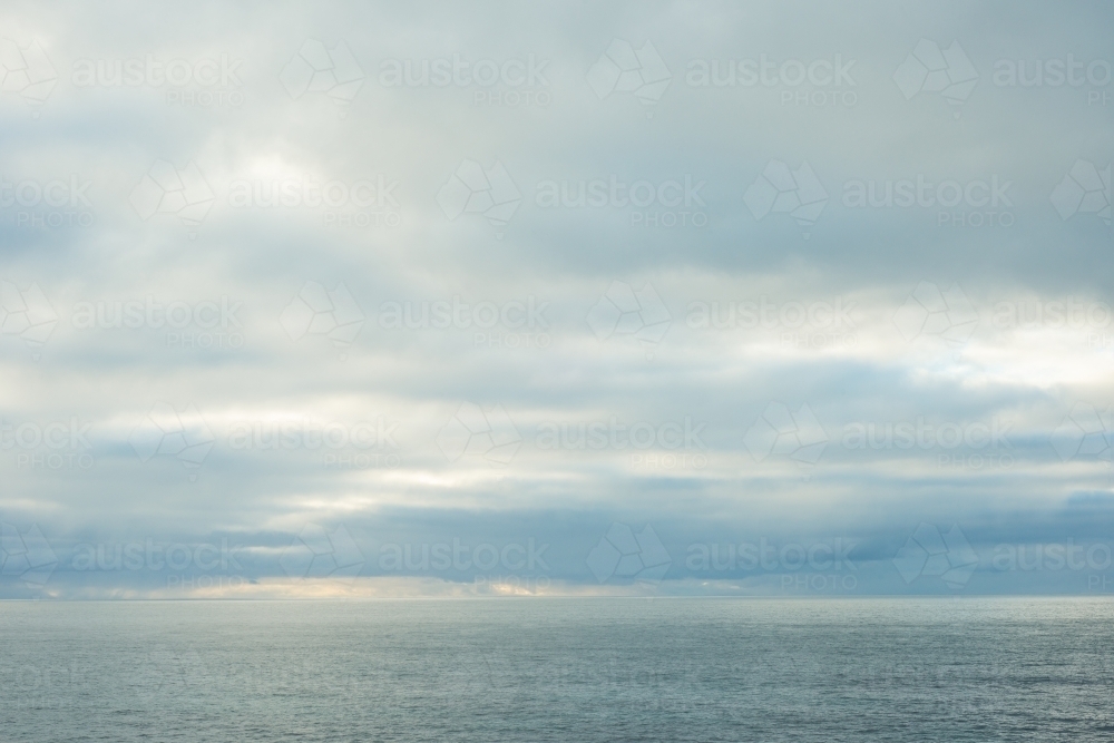 Grey clouds and ocean horizon - Australian Stock Image
