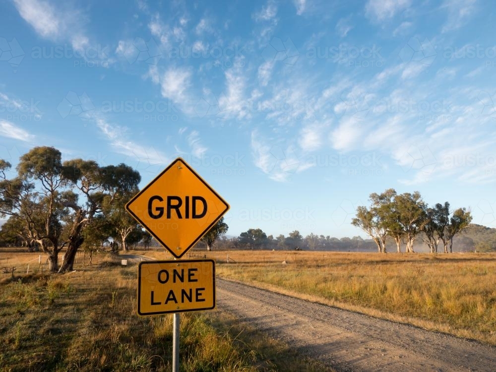 "GRID" and "ONE LANE" sign on a dirt road - Australian Stock Image