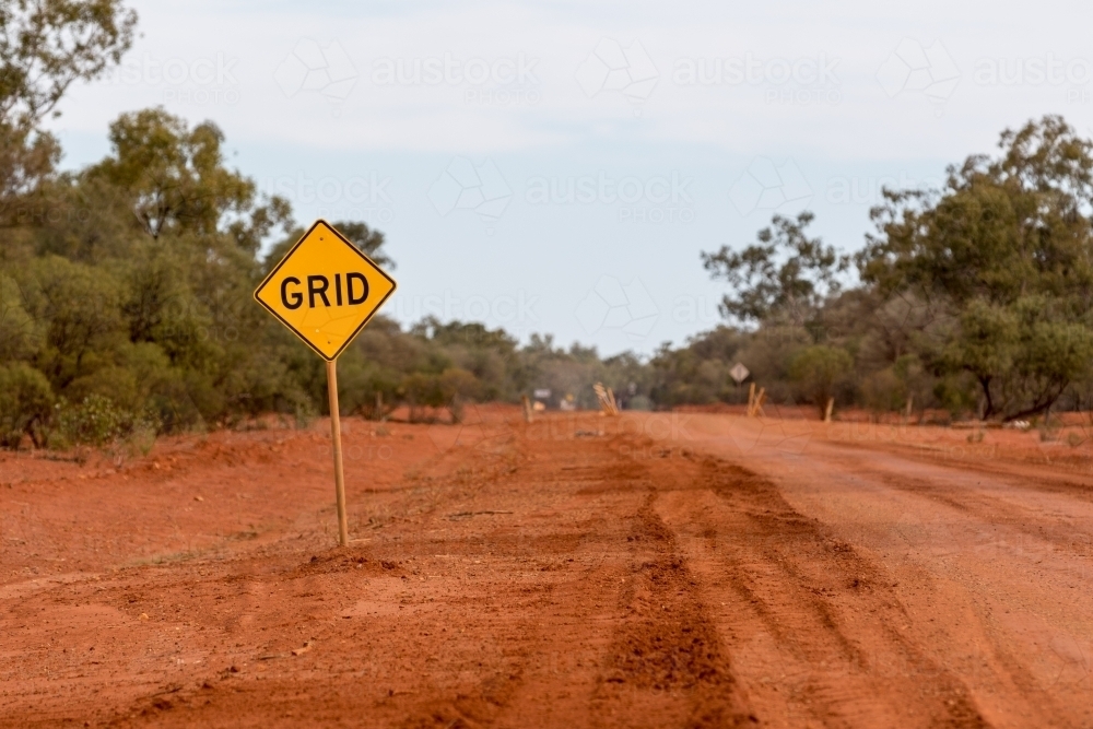 Grid road sign on red dirt road - Australian Stock Image