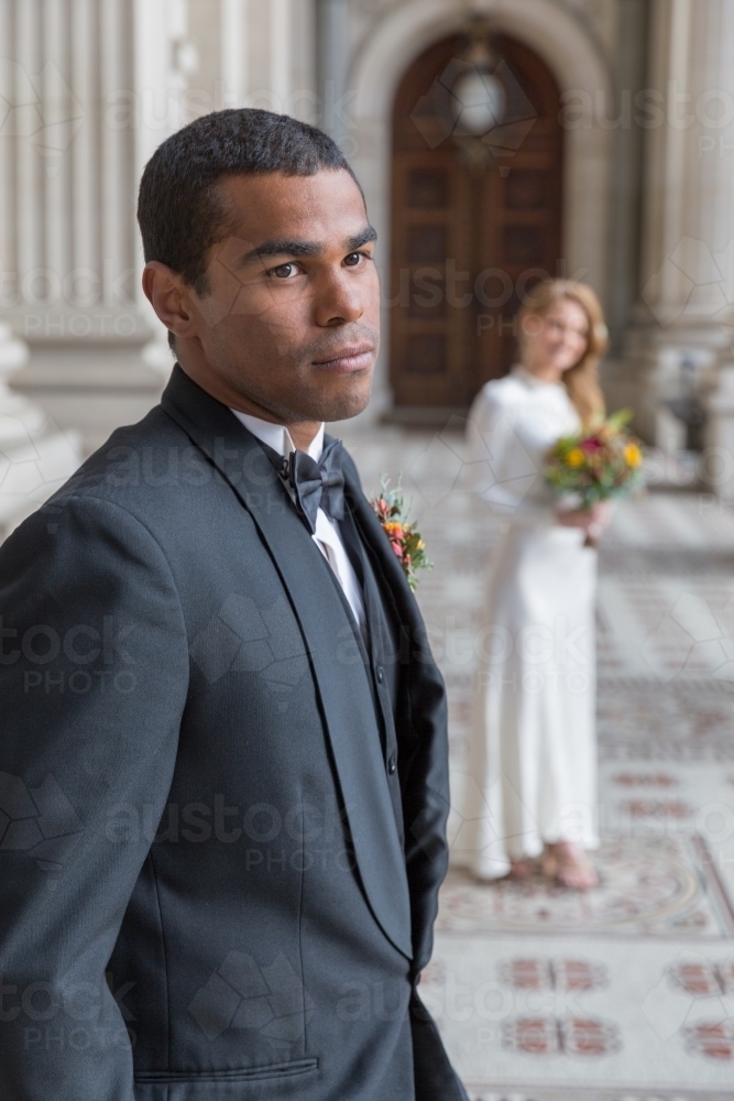 Groom portrait with bride behind - Australian Stock Image